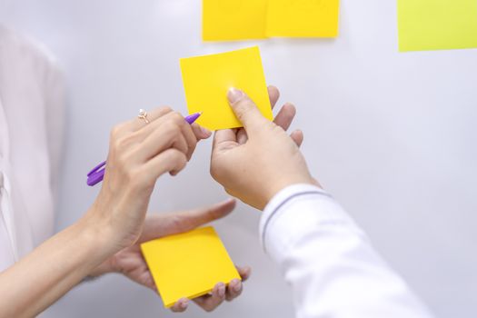 Post-it note with hand on white background