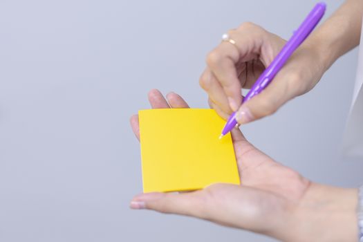 Post-it note with hand on white background