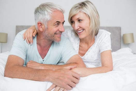 Closeup portrait of a mature couple lying in bed at home