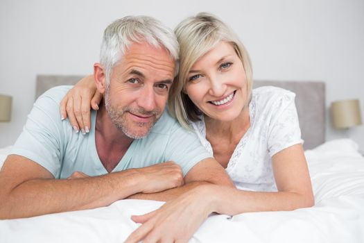 Closeup portrait of a mature couple lying in bed at home