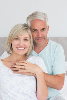 Closeup portrait of a loving mature couple in bed at home