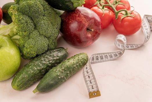 Healthy diet. Fresh vegetables and fruit for healthy diet and a measuring tape