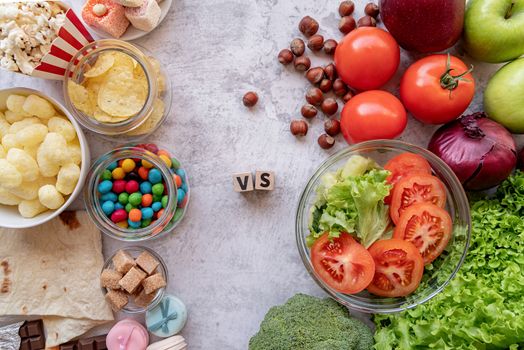 Healthy and unhealthy food concept. Fruit and vegetables vs sweets and potato fries top view flat lay