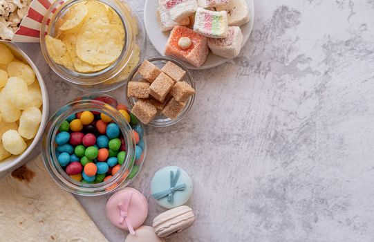 Healthy and unhealthy food concept. Unhealthy food burgers, french fries and sweets top view flat lay with copy space