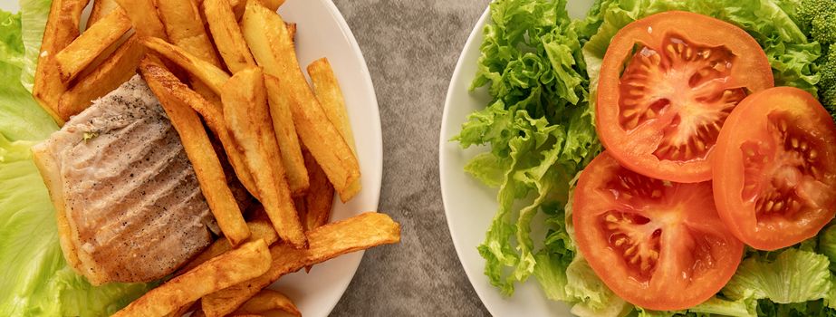 Healthy and unhealthy food concept. Plates with fast food and healthy food top view flat lay