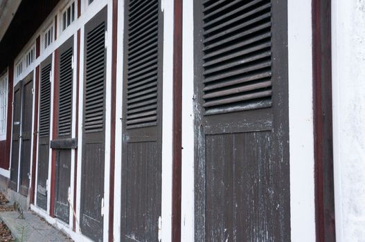 Locked doors at an old abandoned beach showerhouse. In Scandinavian style