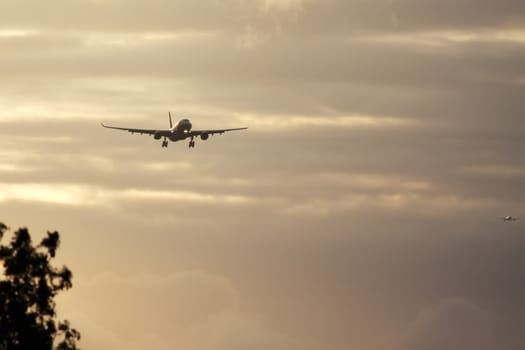 A photography of a jet air plane in sunset sky