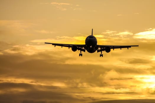 A photography of a jet air plane in sunset sky