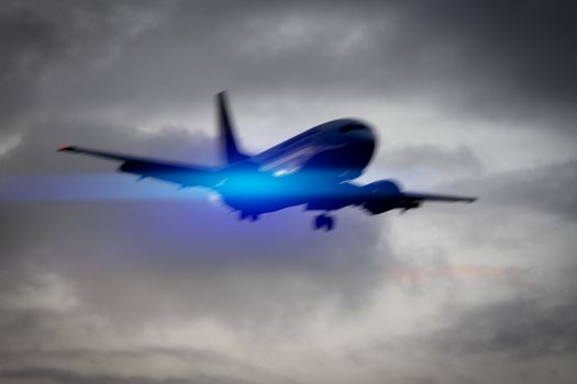 An image of a plane in the sky motion blur with blue light flare