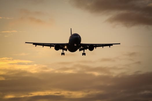 A photography of a jet air plane in sunset sky