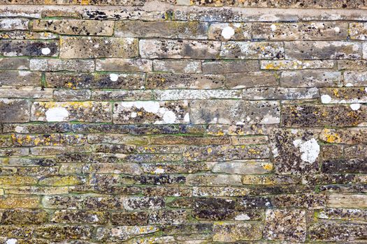 An image of an old weathered stone wall background texture