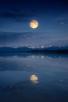An image of the Starnberg Lake by night with full moon near Tutzing Bavaria Germany