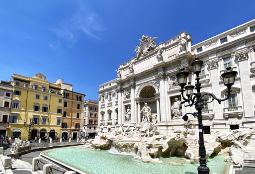 Rome, Italy, May 25th 2020: The Trevi Fountain in Rome with the first tourists after the lockdown due to the coronavirus pandemic. Access to the fountain is still prohibited