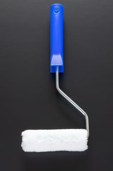 A typical painting roller isolated on black background