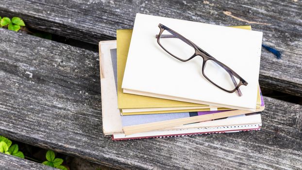 An image of some books and reading glasses background