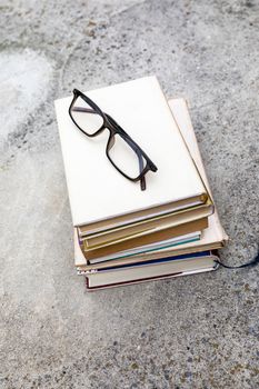 An image of some books and reading glasses background