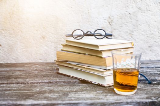 An image of some books and reading glasses background