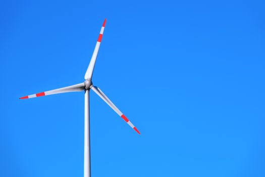 An image of a wind energy detail blue sky