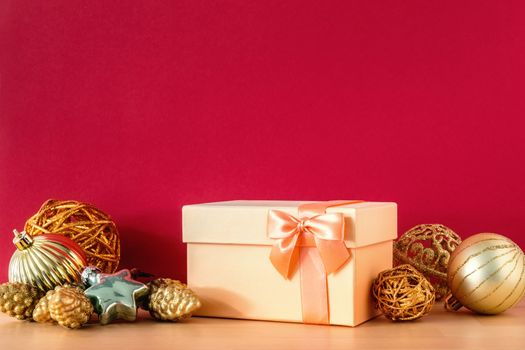 A golden Christmas gift box on red background