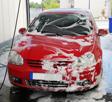 Car washing at the car wash shop with soap