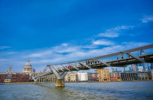 London, United Kingdom - April 18, 2019 - St. Paul's Cathedral across Millennium Bridge and the River Thames in London, UK.