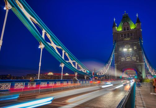 Vehicles pass over Tower Bridge across the River Thames in London, UK.