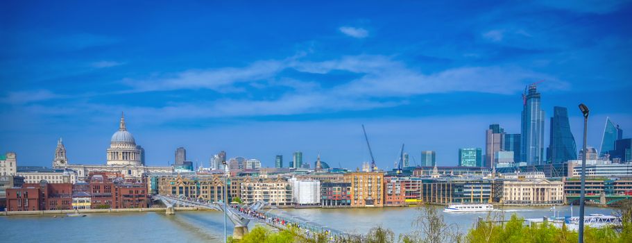 London, United Kingdom - April 18, 2019 - St. Paul's Cathedral across Millennium Bridge and the River Thames in London, UK.