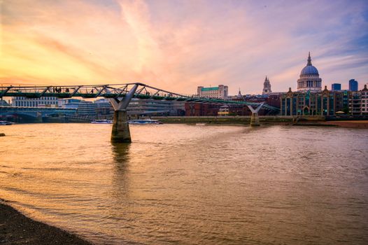 St. Paul's Cathedral across Millennium Bridge and the River Thames in London, UK.