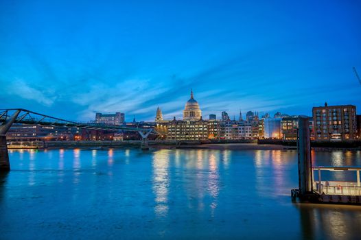 St. Paul's Cathedral across Millennium Bridge and the River Thames in London, UK.