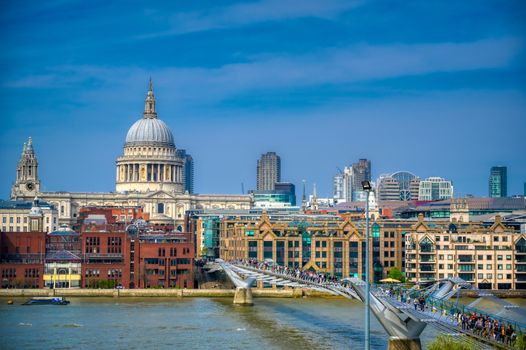 London, United Kingdom - April 18, 2019 - St. Paul's Cathedral across Millennium Bridge and the River Thames in London, UK.