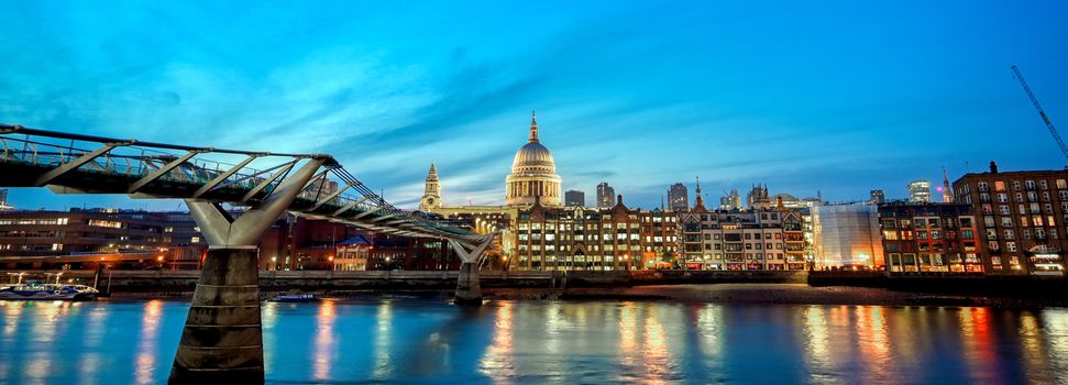 St. Paul's Cathedral across Millennium Bridge and the River Thames in London, UK.