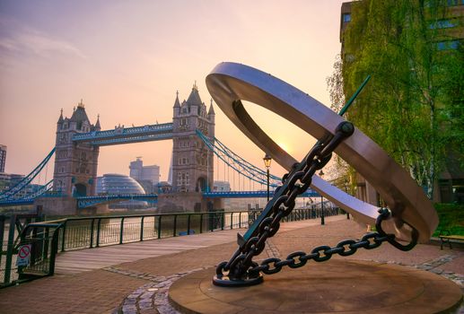 London, United Kingdom - April 17, 2019 : View of Tower Bridge on the River Thames with the sundial, titled Timepiece, that was designed by Wendy Taylor in 1973.