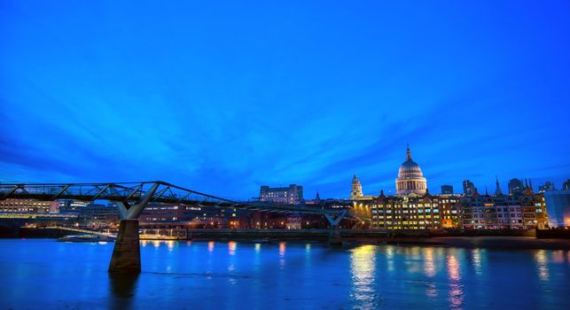 St. Paul's Cathedral across Millennium Bridge and the River Thames in London, UK.