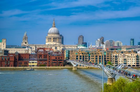 London, United Kingdom - April 18, 2019 - St. Paul's Cathedral across Millennium Bridge and the River Thames in London, UK.