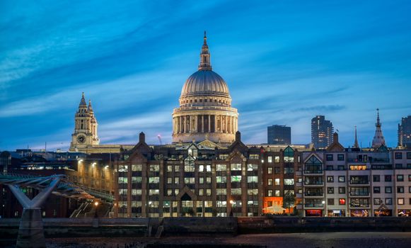 St. Paul's Cathedral across Millennium Bridge and the River Thames in London, UK.