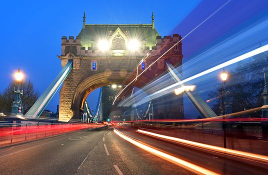 Vehicles pass over Tower Bridge across the River Thames in London, UK.