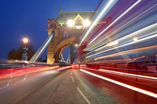 Vehicles pass over Tower Bridge across the River Thames in London, UK.