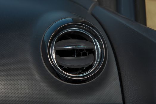 Interior of a car with closeup of  ventilation grille for air conditioning
