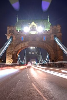 Vehicles pass over Tower Bridge across the River Thames in London, UK.