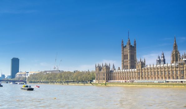 British Parliament along the River Thames on a sunny day in London, UK.