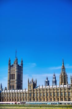 British Parliament along the River Thames on a sunny day in London, UK.