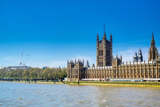 British Parliament along the River Thames on a sunny day in London, UK.