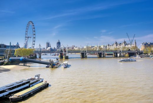 A view along the River Thames on a sunny day in London, UK.