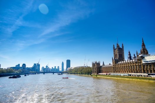 British Parliament along the River Thames on a sunny day in London, UK.