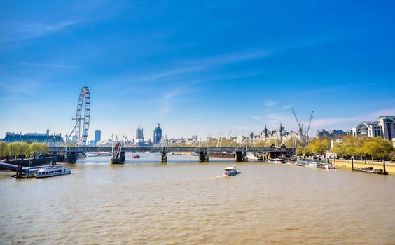 A view along the River Thames on a sunny day in London, UK.