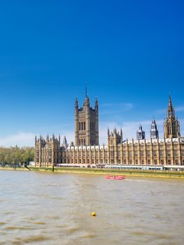 British Parliament along the River Thames on a sunny day in London, UK.