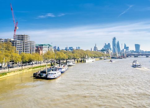 A view along the River Thames on a sunny day in London, UK.