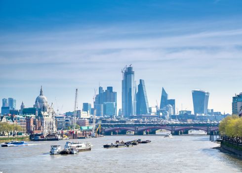 A view along the River Thames on a sunny day in London, UK.