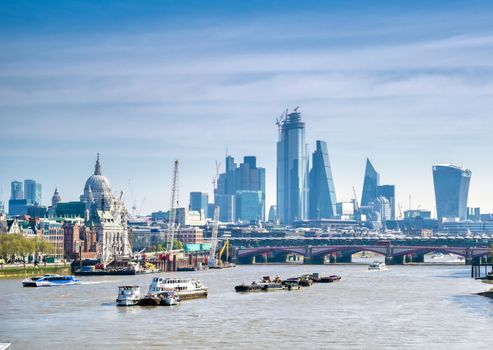 A view along the River Thames on a sunny day in London, UK.