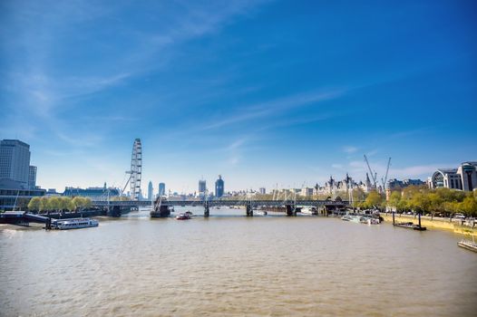 A view along the River Thames on a sunny day in London, UK.